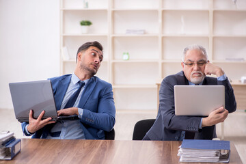 Two male employees working in the office