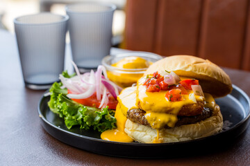 Cheese burger with salad in the restaurant