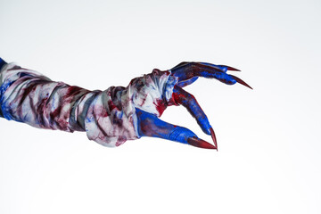 A blue witch hand with red nails, wrapped in a blood-stained bandage against a white background. This eerie, monstrous image evokes demonic, zombie, and ghostly vibes, perfect for Halloween horror.