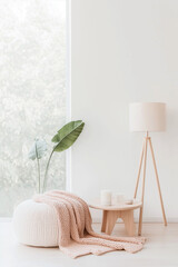 A white room with a white table and a lamp