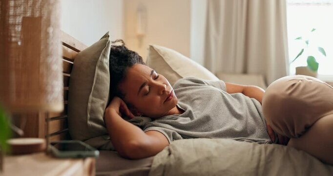 Woman, period and stomach pain in bedroom, cycle and endometriosis or uterus bloating in home. Female person, abdominal ulcer and appendicitis or tummy ache in bed, digestion cramps and colon bug