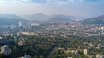 Fototapeta premium Aerial view of Pune city in Maharashtra, India. Skyscrapers, buildings in urban landscape. Foggy sky with hazy horizon. Modern architecture, cityscape with metropolis views. Green trees, structure of