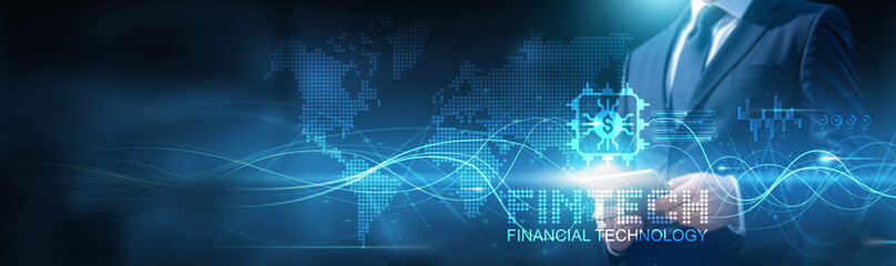 Businessman using tablet on fintech global network connection on financial and technology with data and development of software. Technology and innovation integration. Growth and expansion.