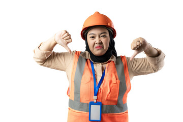 Young Asian female construction worker wearing hijab making a gesture of rejection while looking at the camera, gesture of rejection, industrial and construction concept, isolated white background.