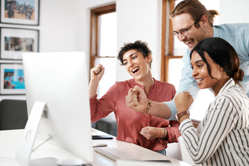 Business, people and excited with fist on computer at office for deadline or task competition. Employees, coworking and smile or happy with bonus or goods news with teamwork and collaboration