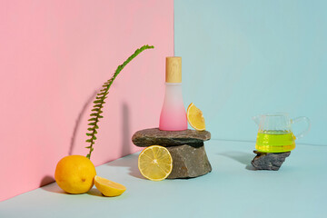 Colorful background photo for cosmetic promotional, which has natural ingredient as lemon. In the center, stone pedestal displaying an unbranded pink cosmetic bottle. Design and copy space