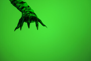 A bloodied witch hand wrapped in bandages, set against a green fire background. This demonic hand...