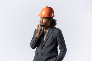 optimistic mens expressions and gestures thinking. stylish asian man with suit and orange helmet on white background. construction or mining business concept photo
