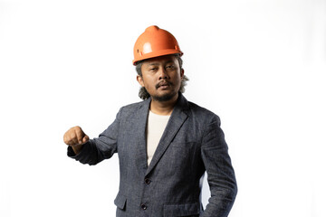 expression of a boss's unacceptability, stylish asian man with suit and orange helmet on white background. construction or mining business concept photo