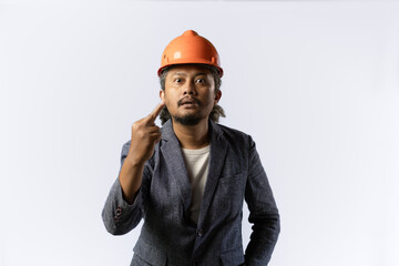 project leader gestures with a middle finger.  stylish asian man with orange suit and helmet on white background. construction or mining business concept photo