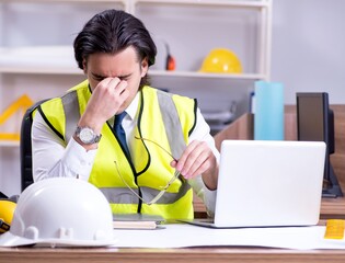 Young male architect working in the office