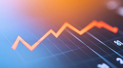 Close-up of downward-trending line graph on digital screen, symbolizing drop in earnings, financial decline visualized with charts and numbers.	