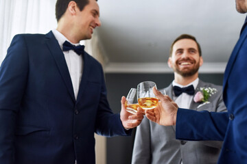 Cheers, wedding and groomsmen with alcohol for celebration of romantic event together. Happy, commitment and male best friends with shot of whiskey for toast and getting ready for marriage ceremony.