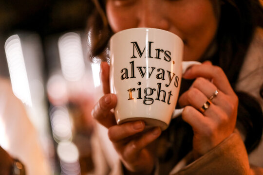 Woman enjoying coffee in Melbourne laneway with'Mrs Always Right' mug