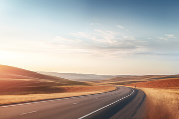 Empty highway in the hills outdoors with blue sky and white clouds