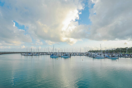 Boats anchored at Airlie Beach Marina on cloudy day