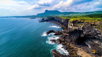 Fototapeta premium The rugged coastline of Jeju Island in South Korea, with volcanic rock formations and waves crashing against the shore