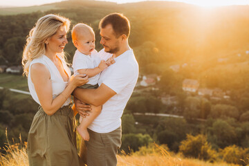 Happy Family Enjoying a Beautiful Sunset in a Scenic Countryside Setting