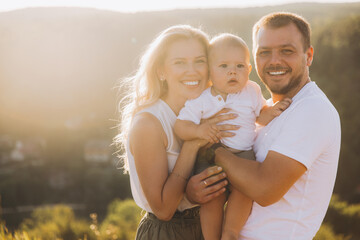 Obraz premium Happy Family Enjoying Sunny Day Outdoors With Smiling Parents and Child