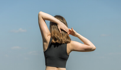 A woman is stretching her arms out to the side