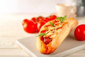 Baguette - sandwich with sausage and fresh vegetables on isolated white background