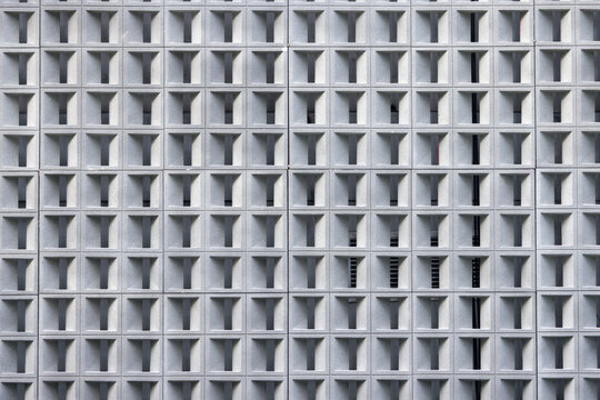 The image is a close up of a building with many small windows.