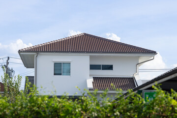 A large house with a brown roof and white trim