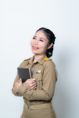 Beautiful Asian female teache pointing to empty copy space isolated on green background.