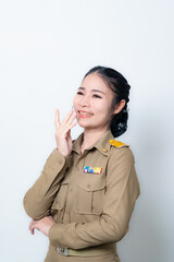 Female Thai government officer in khaki uniforms smiling. Beautiful woman doing winner gesture with arms raised isolated over white background. Concept