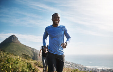 Fitness, man and group running on mountain for cardio workout, competition training and challenge. Teamwork, runner and morning jog in nature for marathon exercise, endurance and healthy body on path