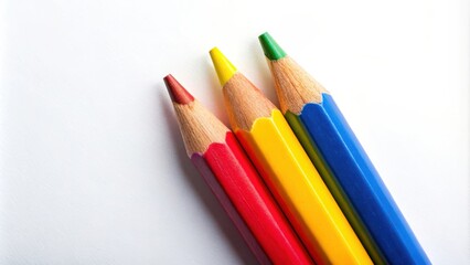 Fototapeta premium Top view of three vibrant color pencils on a white background