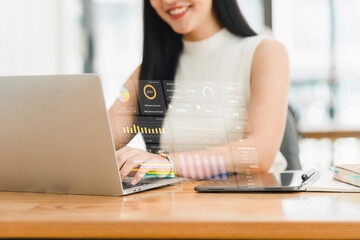 Businesswoman working on laptop with digital data visualization.