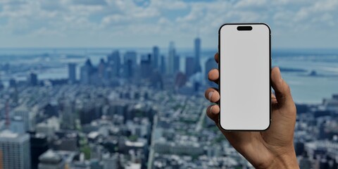 Asian male using smartphone with a blank white screen. New york, skyline, cityscape apps mockup. Vertical phone orientation