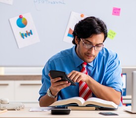 Young male financial manager working in the office