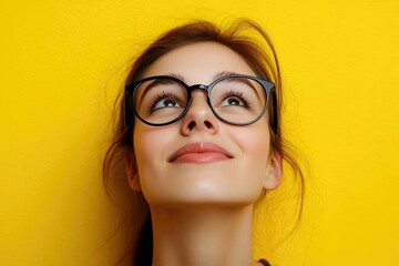 Fototapeta premium Closeup portrait of happy woman in glasses on yellow background.