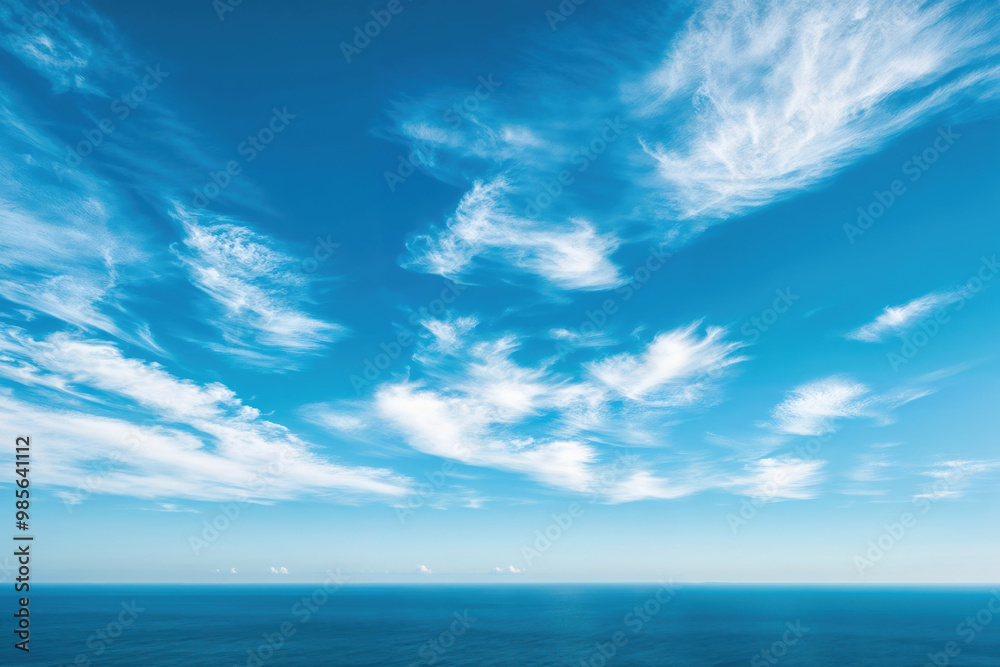 Poster cirrus clouds in the azure sky above a ocean