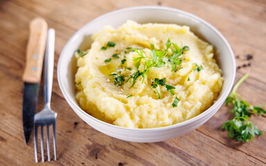 Bowl of Mashed Potatoes with Cutlery on Wooden Background – Comfort Food
