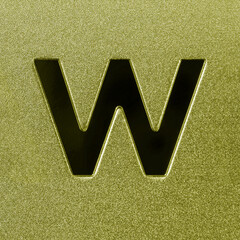Letter W on a golden grained shiny metal surface. English alphabet.