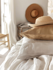 A cozy bedroom scene with a straw hat on a stack of pillows. Perfect for home decor, lifestyle, and bedding inspiration.