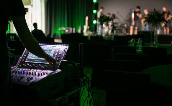 Sound engineer working backstage while preparing audio equipment for a live concert