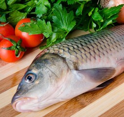 Uncooked fish on cutting board in meal preparation concept