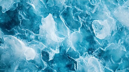 Obraz premium A close-up of shimmering, blue ice fragments, illuminated by light, creating a captivating, textured surface of icy blues and whites.
