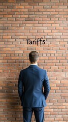 A businessman contemplating tariffs against a brick wall, symbolizing trade challenges and economic decisions.