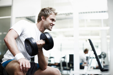 Workout, power and dumbbells with man in gym for training, muscle growth and fitness routine. Personal trainer, strong and sports athlete with person and exercise for energy, wellness and weights