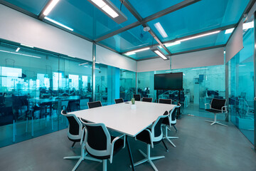 Modern meeting room with a spacious table and black chairs ready for a business gathering