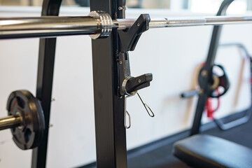 Clamps for holding weights on a barbell in the gym.