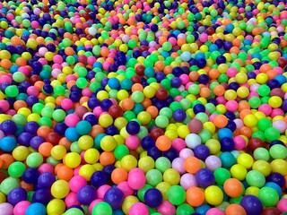 Thousands of colorful plastic balls in a pool known as a ball pool in the indoor kids zone