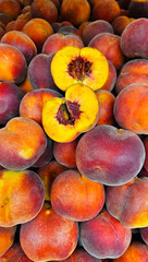 Ripe juicy peaches close up at market, natural fruit background