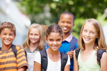 Children, education and portrait of student friends outdoor at school together for development. Diversity, scholarship or smile with boy and girl kids on playground for bonding, learning or study