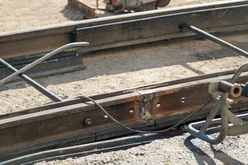Close-up of welding streetcar rails during street repairs in the city. Timely replacement of worn-out tramway rails. Urban reconstruction, infrastructure overhaul